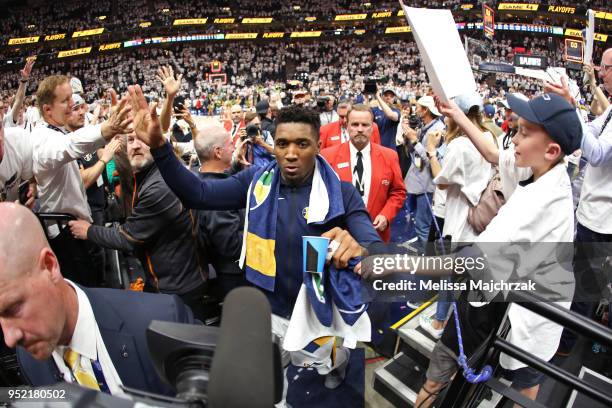 Donovan Mitchell of the Utah Jazz exchanges high fives with fans after Game Four of Round One of the 2018 NBA Playoffs against the Oklahoma City...