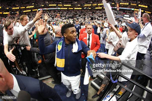 Donovan Mitchell of the Utah Jazz exchanges high fives with fans after Game Four of Round One of the 2018 NBA Playoffs against the Oklahoma City...