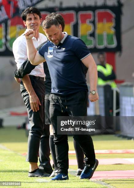 Sporting director Bruno Huebner of Frankfurt speaks with Head coach Pal Dardai of Hertha during the Bundesliga match between Eintracht Frankfurt and...