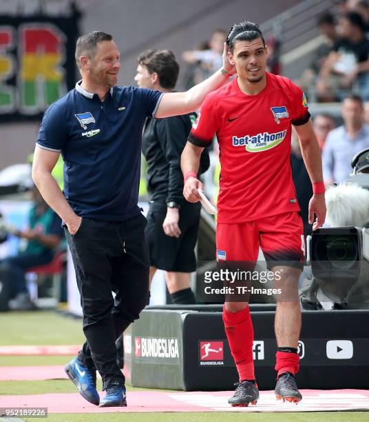 Head coach Pal Dardai of Hertha and Karim Rekik of Hertha laugh during the Bundesliga match between Eintracht Frankfurt and Hertha BSC at...