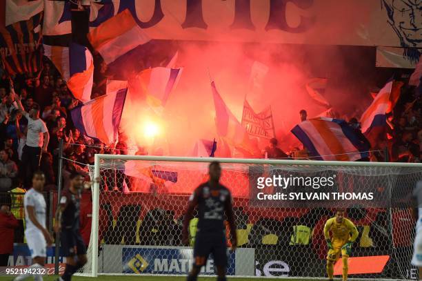 Montpellier's supporters react during the French L1 football match between Montpellier and Saint Etienne, on April 27, 2018 at the La Mosson Stadium...