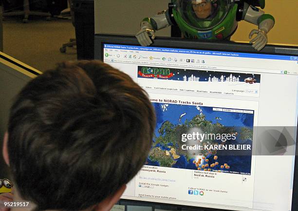 In this illustration, a young boy looks at the website to check on the progress of Santa Claus on December 24, 2009 in Washington, DC. The North...