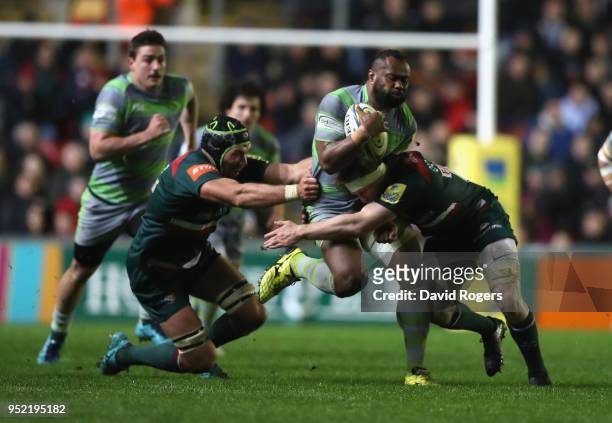 Vereniki Goneva of Newcastle Falcons is tackled by Brendon O'Connor and Graham Kitchener during the Aviva Premiership match between Leicester Tigers...