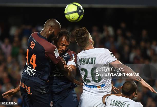 Saint-Etienne's French defender Mathieu Debuchy vies with Montpellier's Brazilian defender Victorio Hilton and Montpellier's Ivorian forward Giovanni...