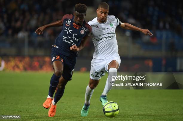 Montpellier's French defender Nordi Mukiele vies with Saint-Etienne's French forward Kevin Monnet-Paquet during the French L1 football match between...