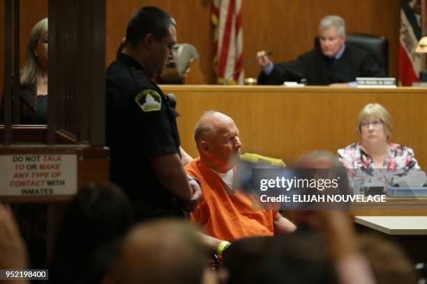 Joseph James DeAngelo is taken on a wheel chair into the courtroom to be arraigned on two counts of murder April 27 in Sacramento, California. I -...