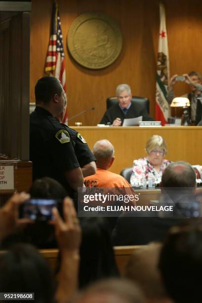 Joseph James DeAngelo is taken on a wheel chair into the courtroom to be arraigned on two counts of murder April 27 in Sacramento, California. -...