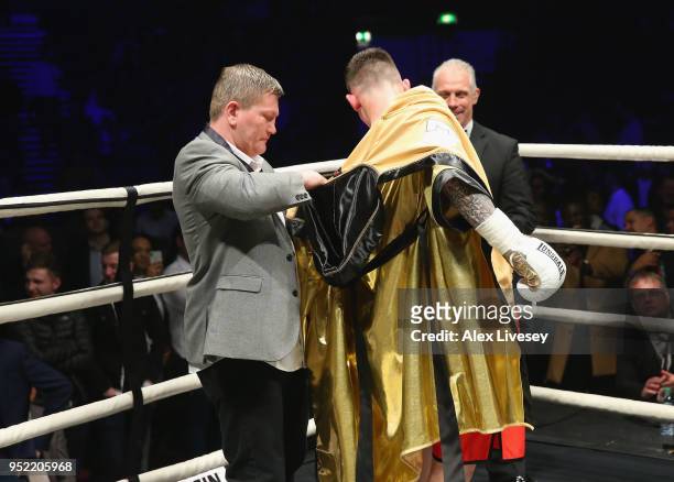 Drew Brown is presented with the golden robe from Ricky Hatton after victory over Tom Young in the Final of the Ultimate Boxxer tournament at...