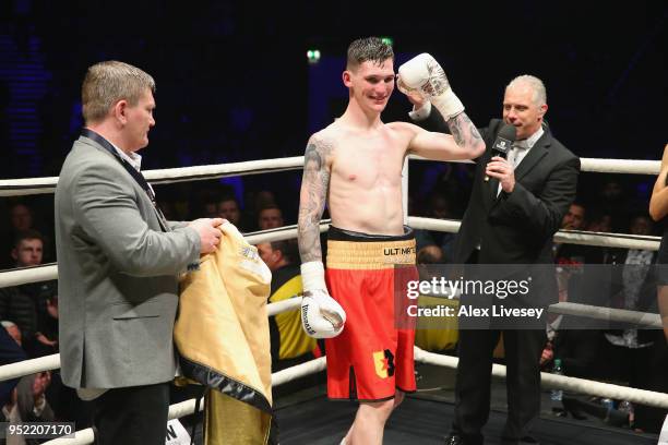 Drew Brown is presented with the golden robe from Ricky Hatton after victory over Tom Young in the Final of the Ultimate Boxxer tournament at...