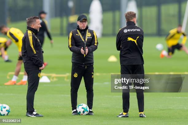 Assistant coach Manfred Schmid of Dortmund, Head coach Peter Stoeger of Dortmund and Assistant coach Joerg Heinrich of Dortmund look on during a...