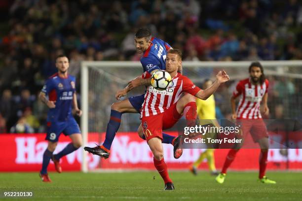 Jason Hoffman of the Jets contests the ball with Oliver Bozanic of Melbourne City during the A-League Semi Final match between the Newcastle Jets and...