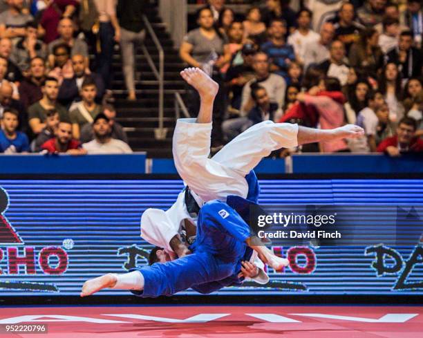 Tommy Macias of Sweden throws Dirk Van Tichelt of Belgium for a wazari in extra time to win their u73kg third round contest during day two of the...