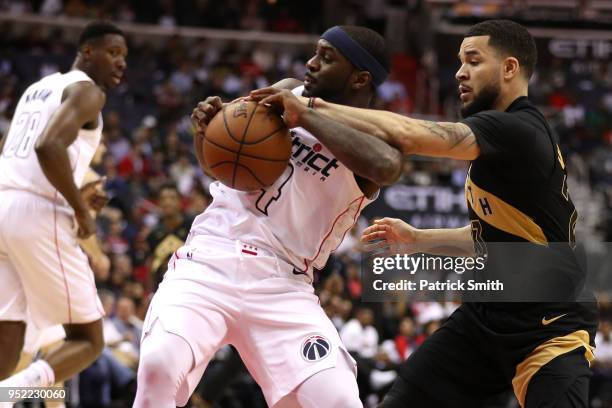 Ty Lawson of the Washington Wizards and Fred VanVleet of the Toronto Raptors battle for the ball in the first half during Game Six of Round One of...