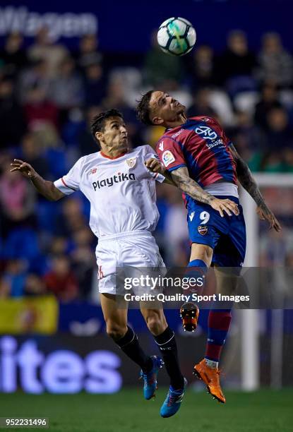 Roger of Levante competes for the ball with Jesus Navas of Sevilla during the La Liga match between Levante and Sevilla at Ciutat de Valencia Stadium...