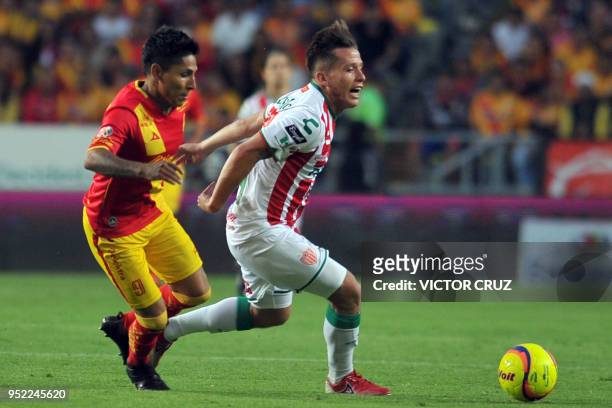 Raul Ruidiaz of Morelia vies for the ball with Fernando Gonzalez of Necaxa during their Mexican Clausura tournament football match at the Morelos...