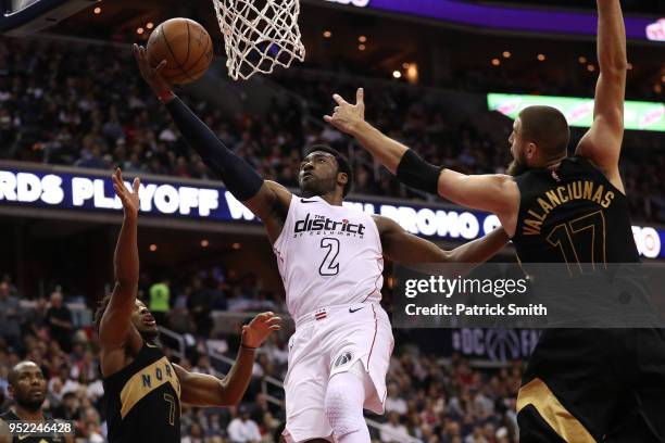John Wall of the Washington Wizards shoots in front of Jonas Valanciunas of the Toronto Raptors in the second half during Game Six of Round One of...