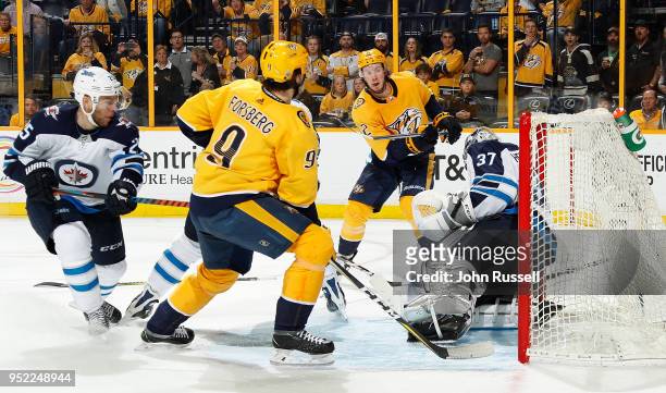 Connor Hellebuyck of the Winnipeg Jets makes the save against Ryan Johansen of the Nashville Predators in Game One of the Western Conference Second...