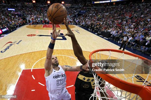 Marcin Gortat of the Washington Wizards has his shot blocked by Serge Ibaka of the Toronto Raptors in the first half during Game Six of Round One of...