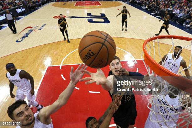Jakob Poeltl of the Toronto Raptors battles for a rebound against the Washington Wizards during Game Six of Round One of the 2018 NBA Playoffs at...