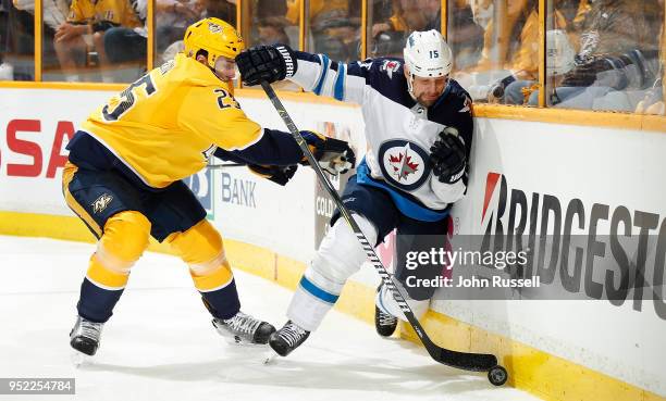 Matt Hendricks of the Winnipeg Jets battles along the boards against Alexei Emelin of the Nashville Predators in Game One of the Western Conference...