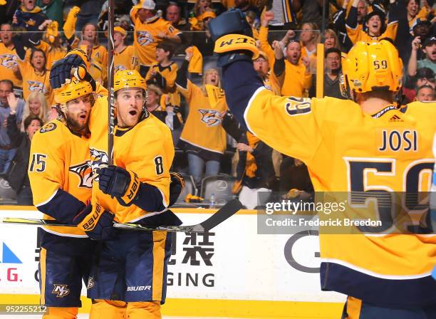 Roman Josi, Craig Smith, and Kyle Turris celebrate after a goal against the Winnipeg Jets during the third period of a 4-1 Jets victory in Game One...