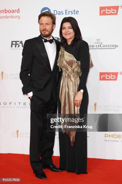 Andreas Pietschmann and Jasmin Tabatabai attend the Lola - German Film Award red carpet at Messe Berlin on April 27, 2018 in Berlin, Germany.