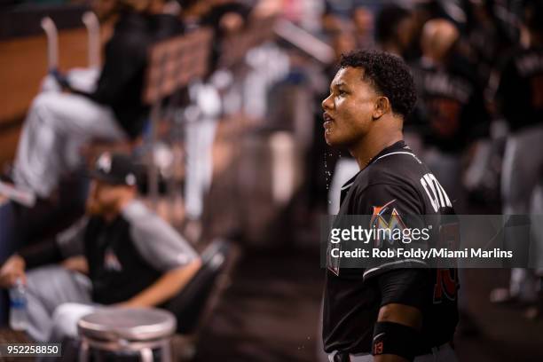 Starlin Castro of the Miami Marlins looks on from the dugout during the game against the Colorado Rockies at Marlins Park on April 27, 2018 in Miami,...