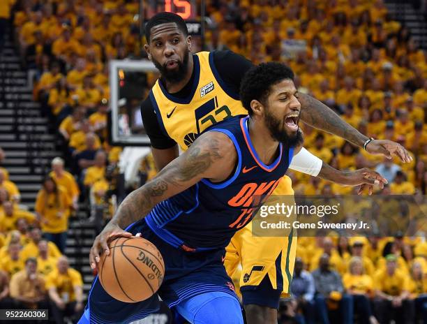 Paul George of the Oklahoma City Thunder drives around the defense of Royce O'Neale of the Utah Jazz in the first half during Game Six of Round One...