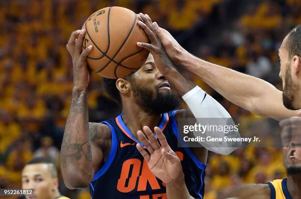 Paul George of the Oklahoma City Thunder tries for the shot past the defense of Rudy Gobert of the Utah Jazz in the first half during Game Six of...