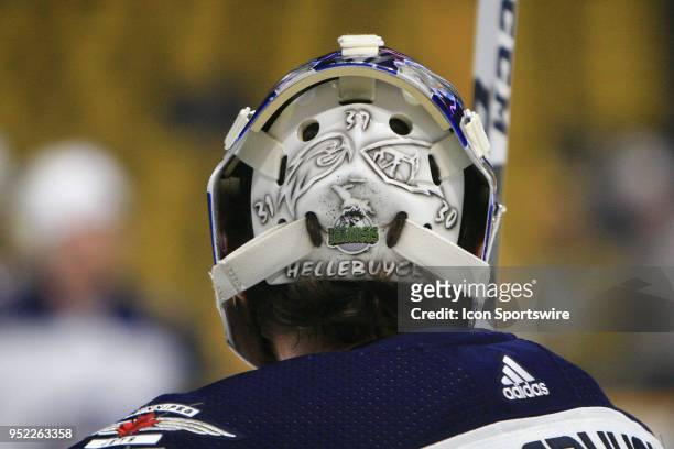 The logo honoring the Humboldt Broncos is shown on the back of the mask of Winnipeg Jets goalie Connor Hellebuyck prior to Game One of Round Two of...