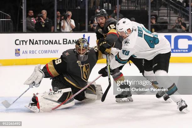 Goaltender Marc-Andre Fleury of the Vegas Golden Knights makes a pas save on the shot from Tomas Hertl of the San Jose Sharks as Jon Merrill defends...