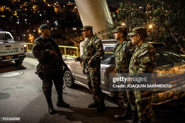 High rank officers talk before patrolling the Comuna 13 neighbourhood in Medellin, Antioquia Department, Colombia, on April 27, 2018. - The Comuna 13...