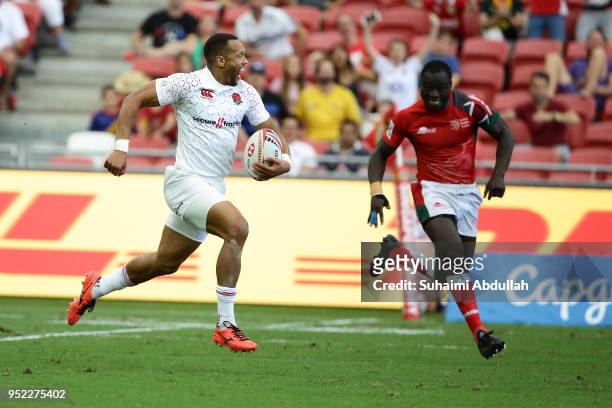 Dan Norton of England runs the ball and scores a try during the 2018 Singapore Sevens Pool B match between Kenya and England at National Stadium on...