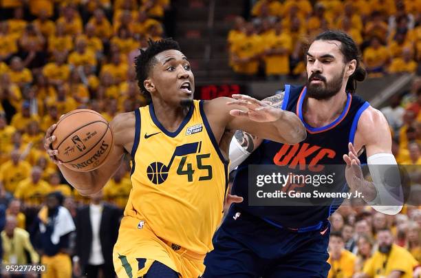 Donovan Mitchell of the Utah Jazz drives past Steven Adams of the Oklahoma City Thunder during Game Six of Round One of the 2018 NBA Playoffs at...