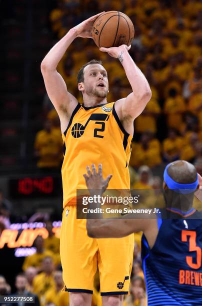 Joe Ingles of the Utah Jazz shoots over Corey Brewer of the Oklahoma City Thunder during Game Six of Round One of the 2018 NBA Playoffs at Vivint...