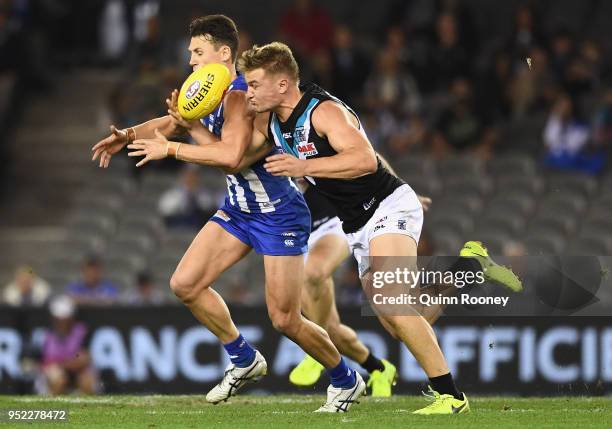 Ben Jacobs of the Kangaroos and Ollie Wines of the Power compete for the ball during the round six AFL match between the North Melbourne Kangaroos...