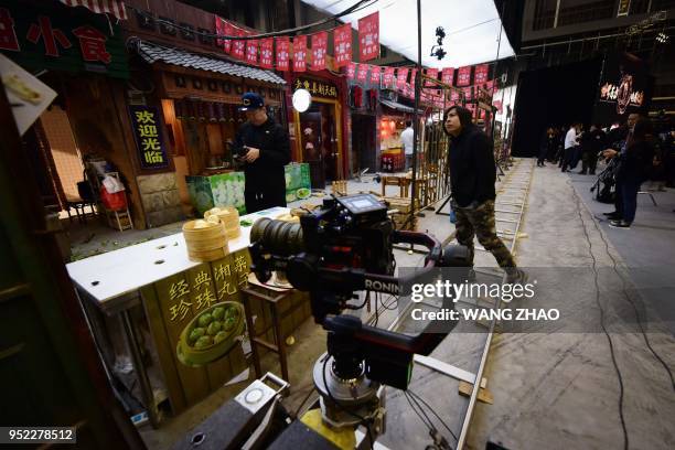 People visit a film set at the Wanda Film industrial park in Qingdao, China's Shandong province on April 28, 2018. - A massive "movie metropolis"...