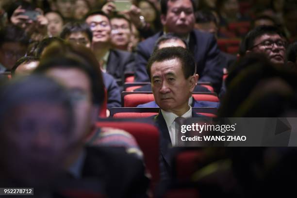 Chairman of China's Wanda Group Wang Jianlin looks on as he attends the opening ceremony of the Wanda Qingdao Movie Metropolis in Qingdao, China's...