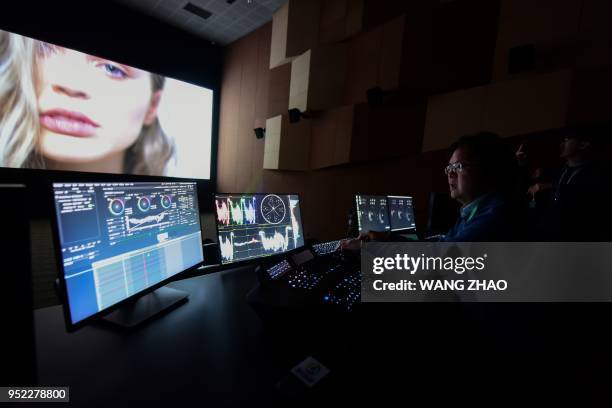 Producer performs colour correction at a film post-production studio at Wanda Film industrial park in Qingdao, China's Shandong province on April 28,...