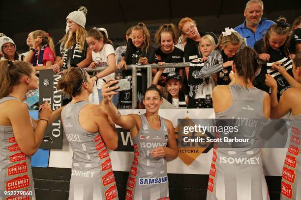 Madi Robinson of the Magpies poses for a photo with fans in the crowd during the Suncorp Super Netball round 1 match between the Melbourne Vixens and...