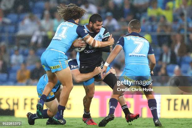 Andrew Fifita of the Sharks is tackled during the round eight NRL match between the Gold Coast Titans and Cronulla Sharks at Cbus Super Stadium on...