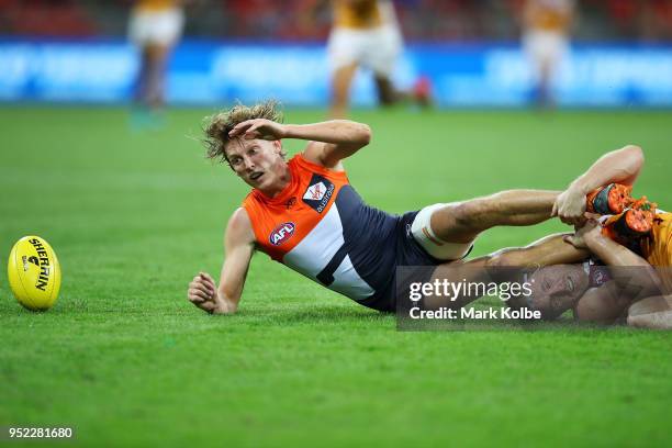 Lachie Whitfield of the Giants is tackled Daniel Rich of the Lions during the round six AFL match between the Greater Western Sydney Giants and the...