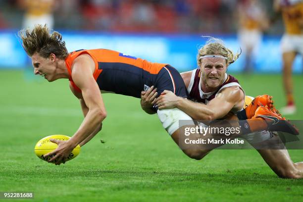 Lachie Whitfield of the Giants is tackled Daniel Rich of the Lions during the round six AFL match between the Greater Western Sydney Giants and the...