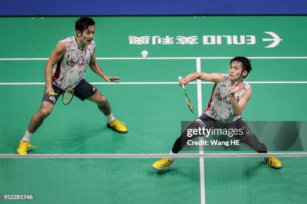 Takeshi Kamura and Keigo Sonoda of Japan hits a return during their man's doubles Semi final match against Liu Cheng and Zhang Nan of China at the...