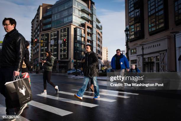 Pedestrians cross Bethesda Avenue at Woodmont Avenue in downtown Bethesda on Saturday December 17, 2016. A new land use plan for Bethesda, Maryland...