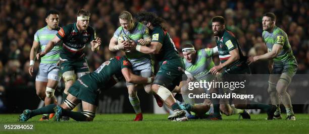 Alex Tait of Newcastle Falcons is tackled during the Aviva Premiership match between Leicester Tigers and Newcastle Falcons at Welford Road on April...
