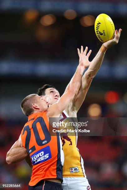 Adam Tomlinson of the Giants and Oscar McInerney of the Lions compete for the ball during the round six AFL match between the Greater Western Sydney...