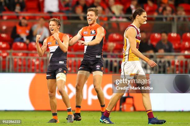 Lachie Whitfield of the Giants celebrates with his team mates after kicking a goal during the round six AFL match between the Greater Western Sydney...