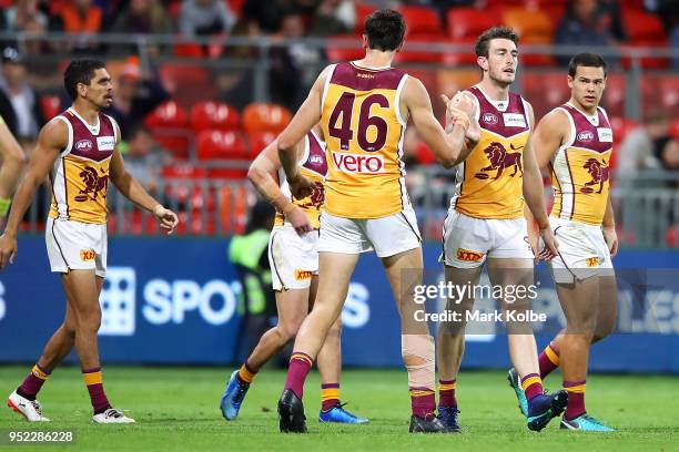 Daniel McStay of the Lions celebrates with his team mates after kicking a goal during the round six AFL match between the Greater Western Sydney...