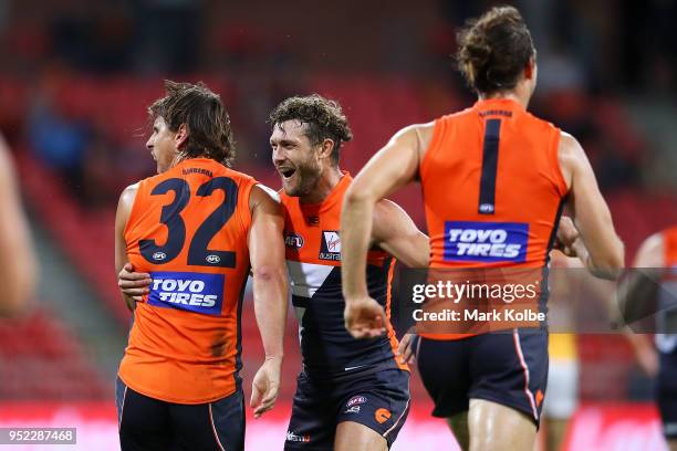 Ryan Griffen of the Giants celebrates with his team mates after kicking a goal during the round six AFL match between the Greater Western Sydney...